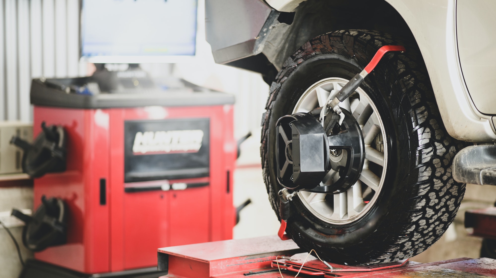 Car wheel mounted on an alignment machine during a suspension check